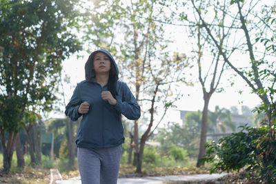 Portrait of woman jogging on road