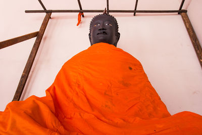 Low angle view of statue against cross