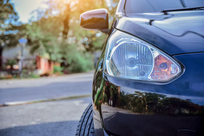 Close-up of car on road