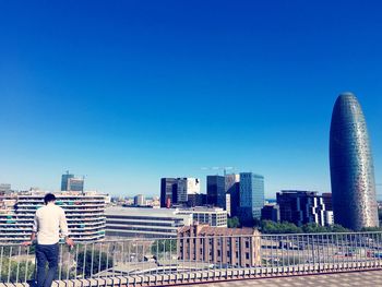 Buildings in city against blue sky