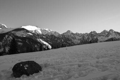 Scenic view of mountains against clear sky during winter