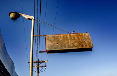 Low angle view of ship against clear blue sky