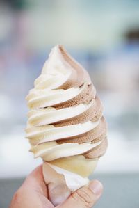 Cropped hand holding ice cream cone