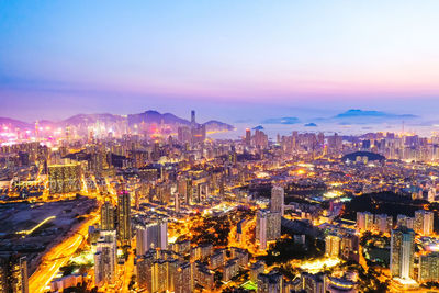 High angle view of illuminated buildings against sky at night