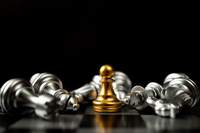 Close-up of chess pieces against black background