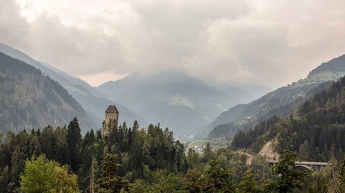 Panoramic view of trees and mountains against sky