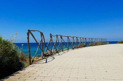 View of beach against clear blue sky