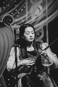 Young woman playing guitar