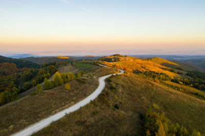 Aerial drone view of winding mountain road at autumn