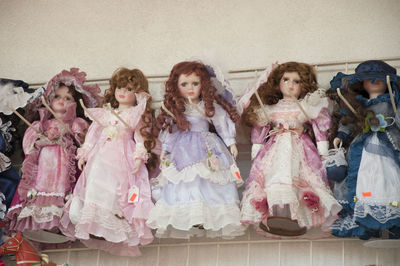 Low angle view of dolls hanging at store for sale