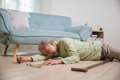 High angle view of woman sitting on sofa at home