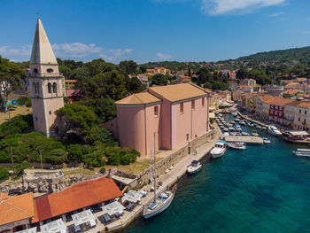 High angle view of townscape by sea against sky