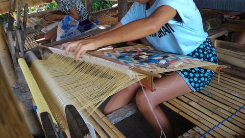 Midsection of female workers working on textile industry