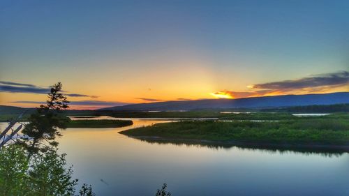 Scenic view of lake against sky during sunset