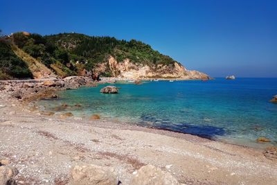 Scenic view of sea against clear blue sky