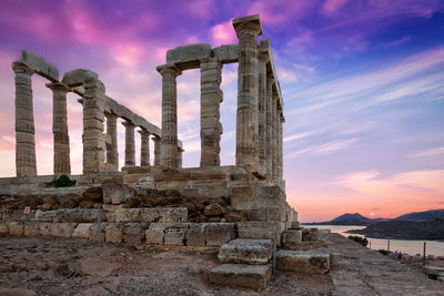 Stone structure against sky during sunset