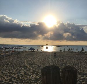 Scenic view of beach against sky during sunset