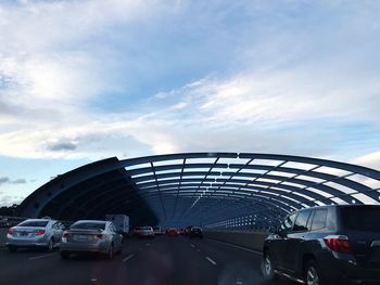 Traffic on road in city against sky