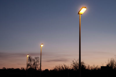 Low angle view of street lights against the sky