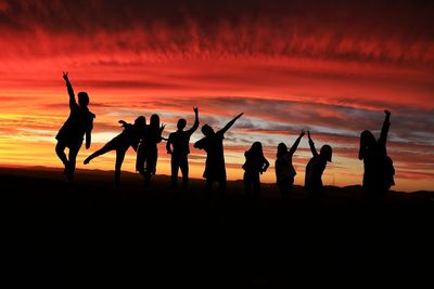 Silhouette of people at sunset