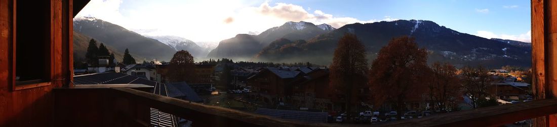 Panoramic view of buildings and mountains against sky
