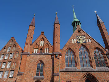 Low angle view of buildings against blue sky