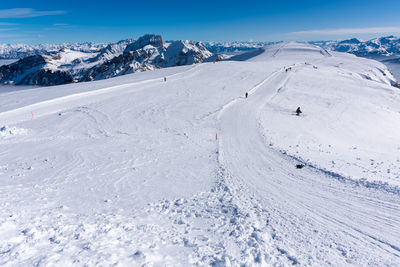 Scenic view of snow covered mountains against sky