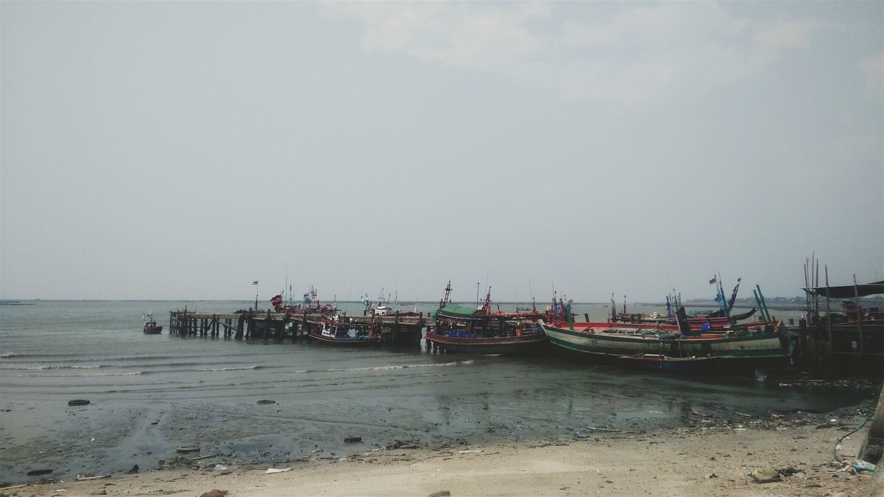 sea, beach, water, nautical vessel, shore, sand, boat, moored, transportation, horizon over water, mode of transport, sky, tranquility, tranquil scene, nature, copy space, scenics, clear sky, incidental people, day