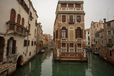 Canal amidst buildings in city