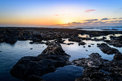 Scenic view of sea against sky at sunset