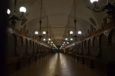 Illuminated lights hanging on ceiling at night