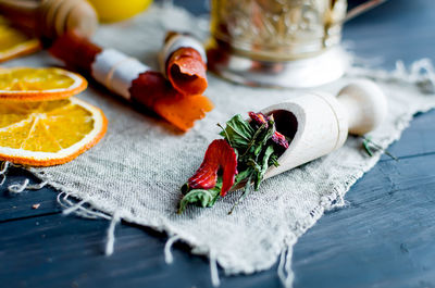 Green tea leaves with strawberry in a wooden spoon