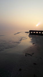 Scenic view of beach against sky during sunset