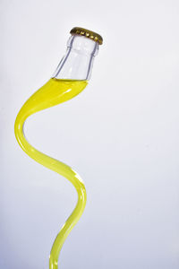 Close-up of yellow glass against white background