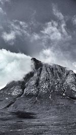 Scenic view of mountains against cloudy sky