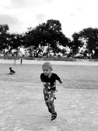 Full length of boy playing on field