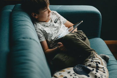 Midsection of boy holding mobile phone