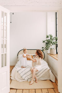 Rear view of couple sitting on floor