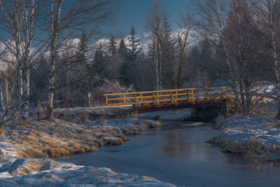 Bridge over river during winter