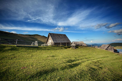 House on field against sky