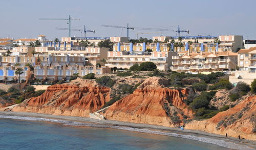 Buildings in city against clear sky