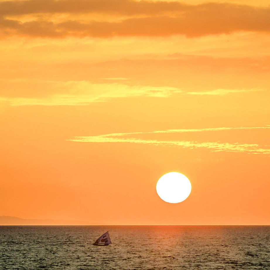 SCENIC VIEW OF SUNSET OVER SEA