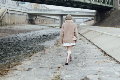 Rear view of woman walking in water