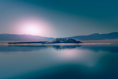 Scenic view of lake against sky during sunset