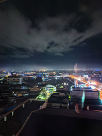 High angle view of illuminated buildings against sky at night