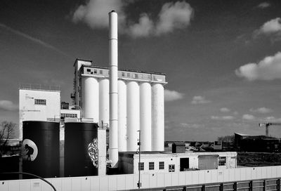 View of factory against sky during sunny day