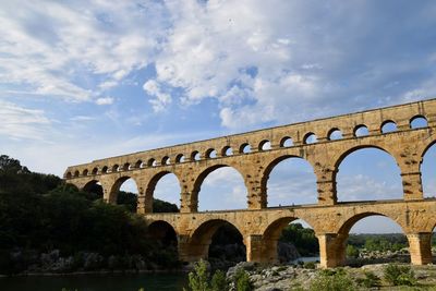 Low angle view of arch bridge against sky