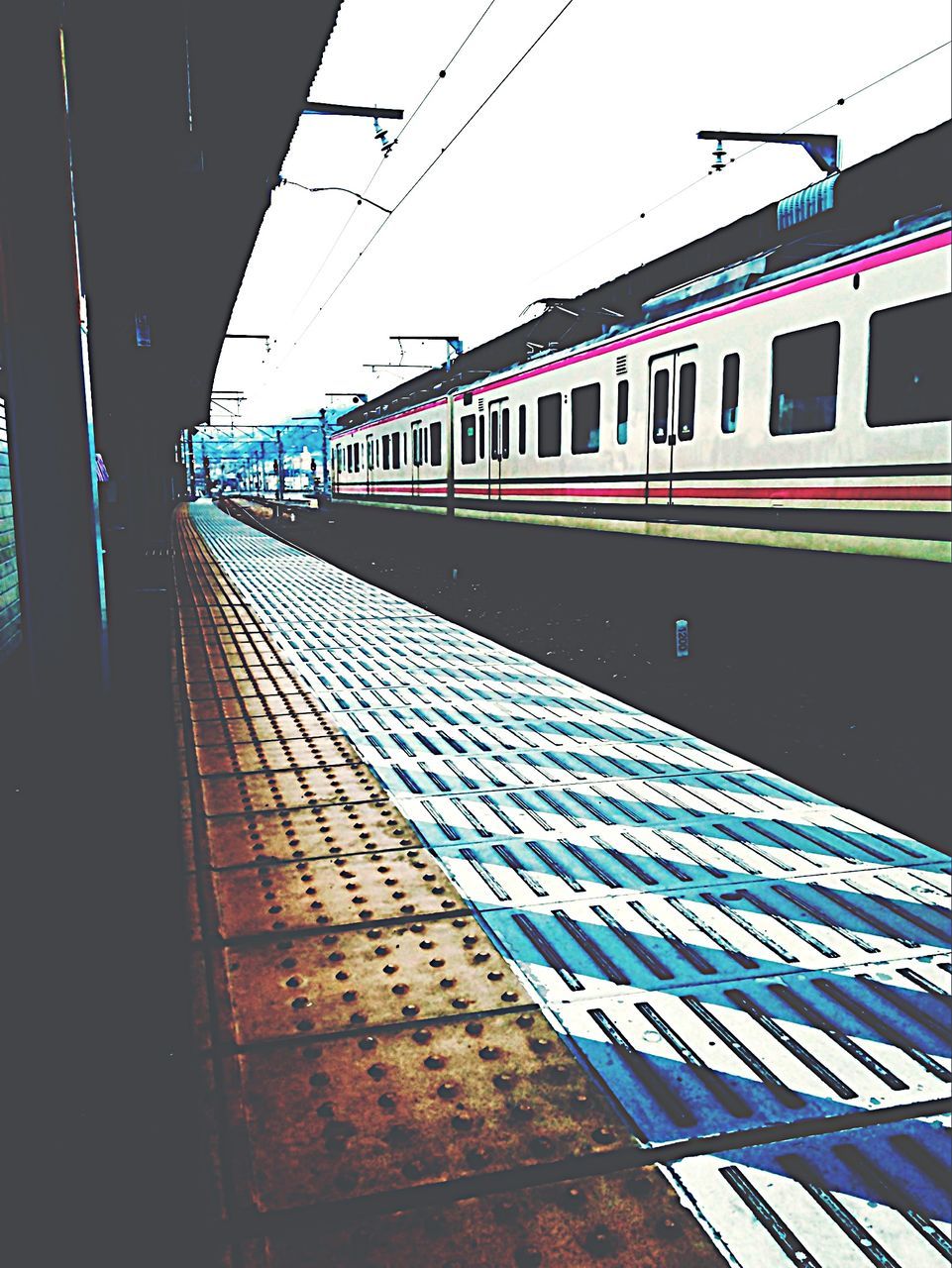 transportation, public transportation, railroad track, railroad station platform, rail transportation, railroad station, mode of transport, clear sky, train - vehicle, travel, architecture, built structure, journey, passenger train, public transport, blue, sky, building exterior, on the move, no people