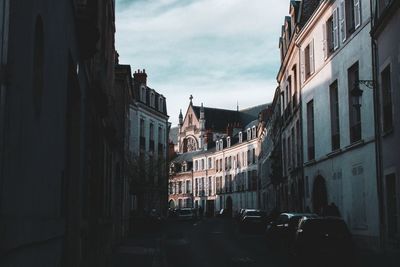 Street amidst buildings in city against sky