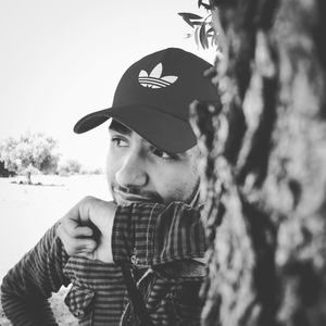 Portrait of young man looking away outdoors
